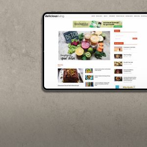 Tablet showing deliciousliving.com page with featured wellness articles.